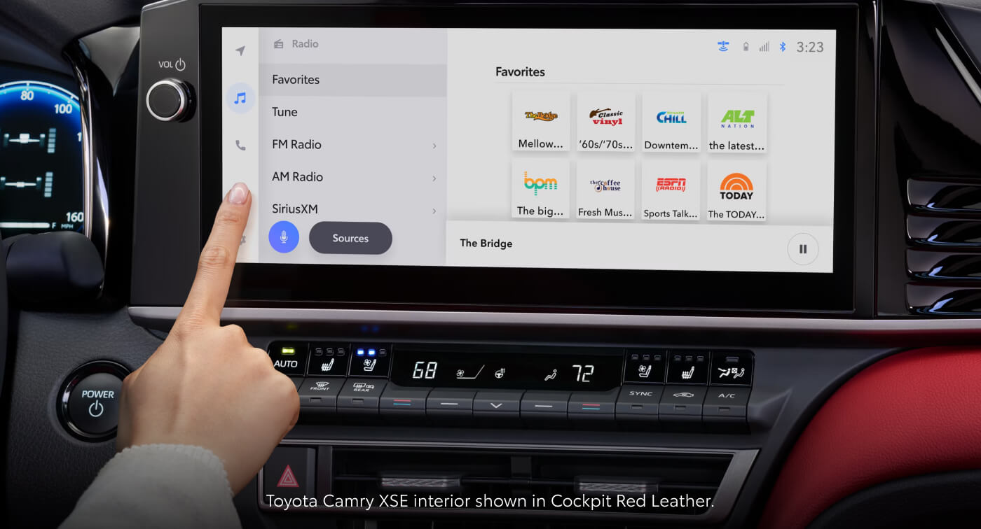 Close-up detail shot of 2026 Toyota Camry XSE featuring 12.3-inch touchscreen, climate control panel, and Cockpit Red leather interior.